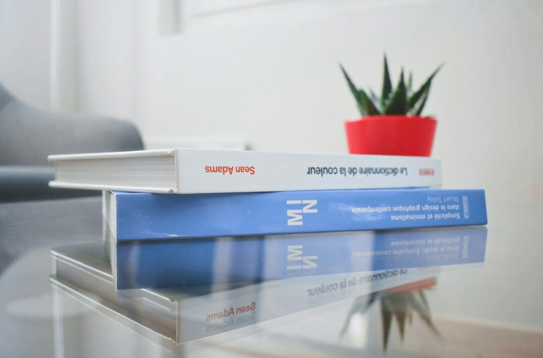 Stack of public contract documents and folders on a table